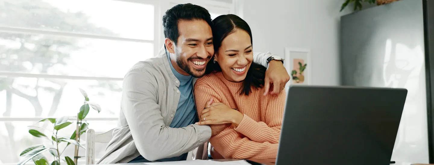 A couple explores estate planning options online, including strategies such as last survivor life insurance to help protect assets and preserve wealth for future generations.