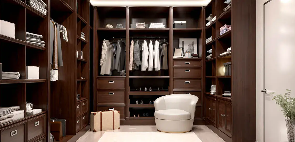 Spacious walk-in closet featuring rich wood cabinetry, organized shelving, and elegant storage solutions, designed by Closet Institute of America (CIA).