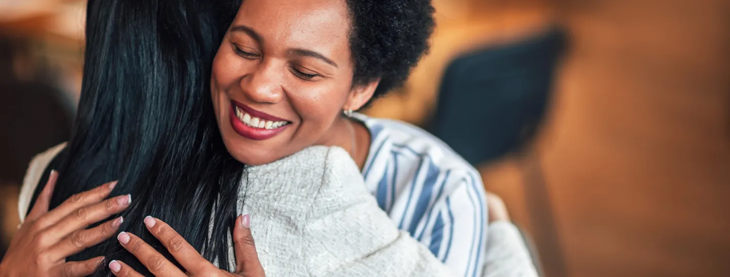 Two women hugging supportively